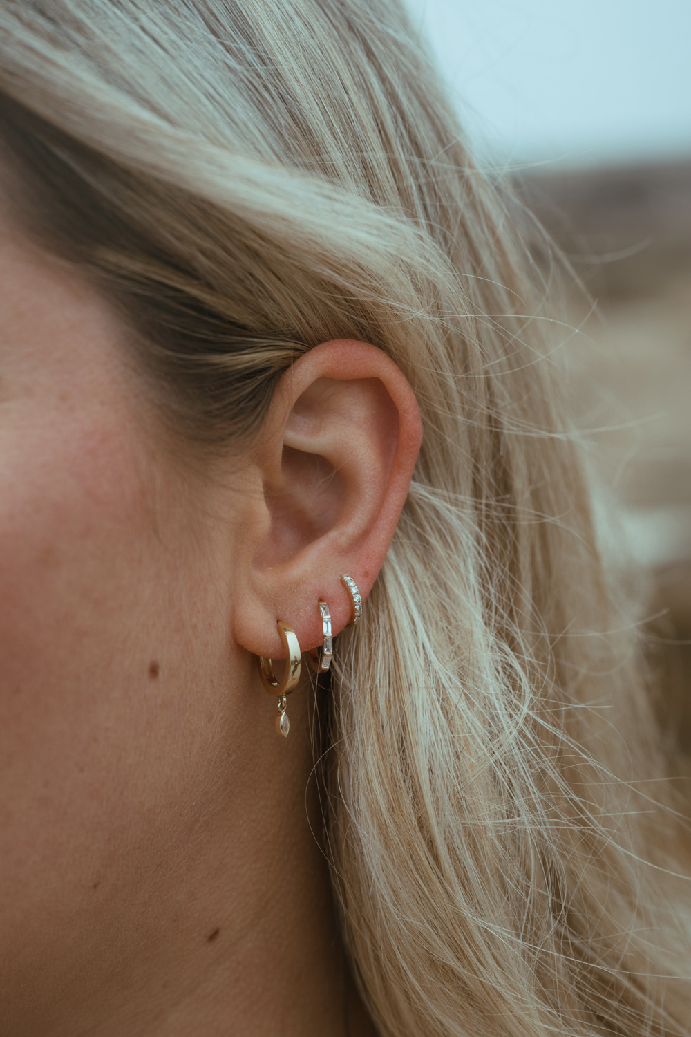 Alia huggie earrings on ear